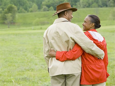 simsearch:640-01358246,k - Rear view of a senior man and a senior woman with their arms around each other Stock Photo - Premium Royalty-Free, Code: 640-02767521