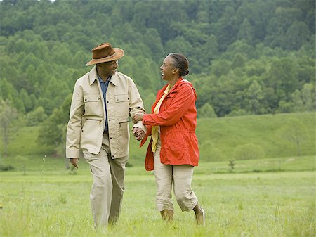 simsearch:640-02767411,k - Senior man and a senior woman walking in a field Stock Photo - Premium Royalty-Free, Code: 640-02767531