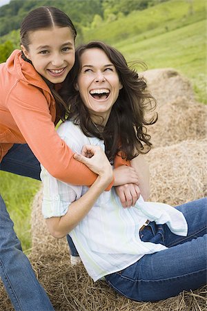 Portrait of a girl hugging her mother from behind Stock Photo - Premium Royalty-Free, Code: 640-02767570