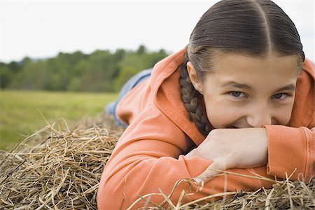 fun kid 10 - Portrait of a girl leaning over a haystack Stock Photo - Premium Royalty-Free, Code: 640-02767572