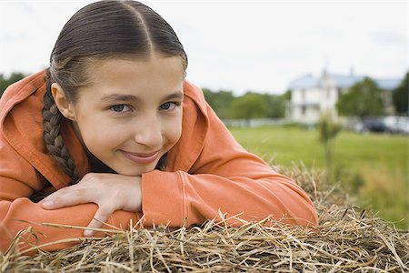 fun kid 10 - Portrait of a girl leaning over a haystack Stock Photo - Premium Royalty-Free, Code: 640-02767573