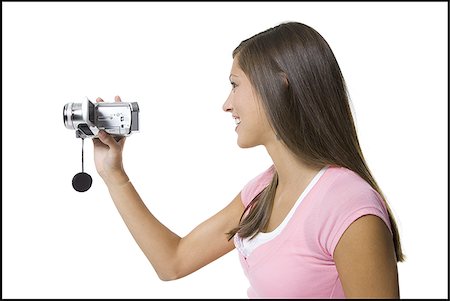 saw - Profile of a young woman holding a video camera Stock Photo - Premium Royalty-Free, Code: 640-02767637