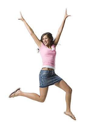 simsearch:640-03257317,k - A young woman jumping and smiling Fotografie stock - Premium Royalty-Free, Codice: 640-02767630