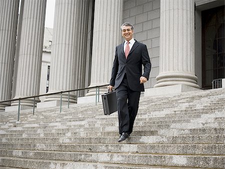 simsearch:640-01355872,k - Low angle view of a male lawyer walking down the steps of a courthouse Foto de stock - Royalty Free Premium, Número: 640-02767815