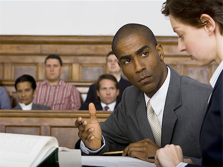 simsearch:640-02767891,k - A male lawyer looking at another lawyer in a courtroom Foto de stock - Sin royalties Premium, Código: 640-02767866