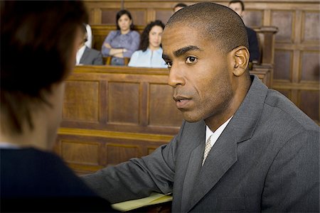 simsearch:640-02767891,k - A male lawyer looking at another lawyer in a courtroom Foto de stock - Sin royalties Premium, Código: 640-02767868