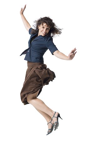 A young woman jumping with her arms raised Stock Photo - Premium Royalty-Free, Code: 640-02767907