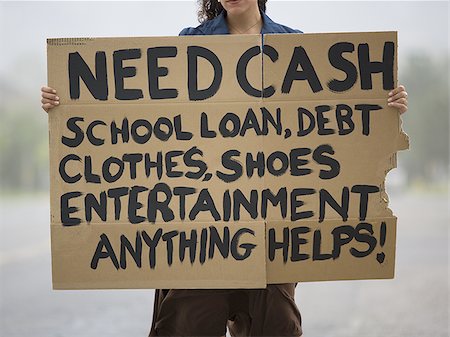 simsearch:640-02950851,k - Portrait of a young woman holding a work-wanted sign Stock Photo - Premium Royalty-Free, Code: 640-02767916