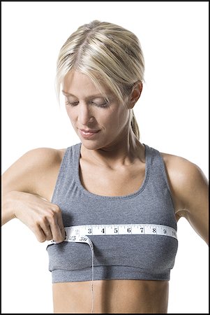 simsearch:640-01353414,k - A young woman measuring her chest with a measuring tape Stock Photo - Premium Royalty-Free, Code: 640-02767983