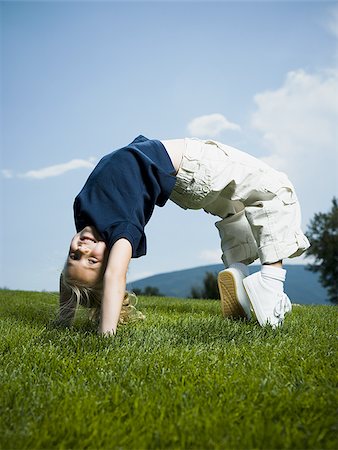 Low angle view of a girl jumping and smiling Stock Photo - Premium Royalty-Free, Code: 640-02768038