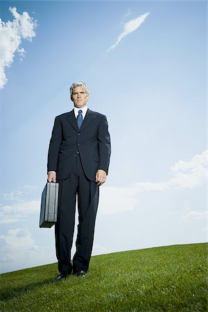 simsearch:640-02768050,k - Low angle view of a businessman holding a briefcase Foto de stock - Royalty Free Premium, Número: 640-02768044