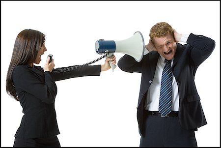 simsearch:640-01360985,k - Profile of a teenage girl shouting in a megaphone with a businessman covering his ears Foto de stock - Royalty Free Premium, Número: 640-02768102
