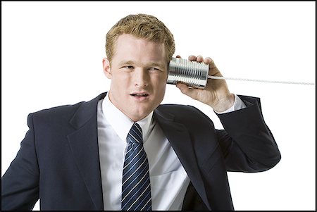 Portrait of a businessman using a tin can phone Fotografie stock - Premium Royalty-Free, Codice: 640-02768119