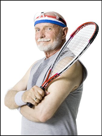 elderly eyes - Portrait of a senior man holding a tennis racket Stock Photo - Premium Royalty-Free, Code: 640-02768174