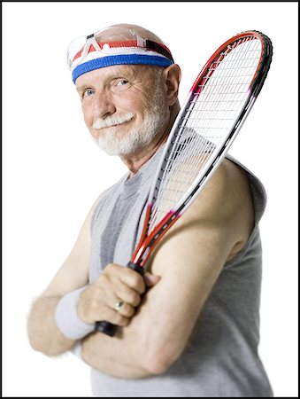 Portrait of a senior man holding a tennis racket Stock Photo - Premium Royalty-Free, Code: 640-02768175