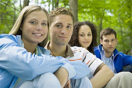 Portrait of two young women and two young men sitting and smiling Stock Photo - Premium Royalty-Free, Code: 640-02768228