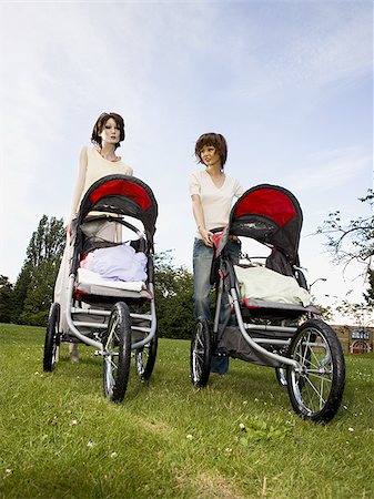 Low angle view of two mannequins portraying mothers pushing prams Stock Photo - Premium Royalty-Free, Code: 640-02768373