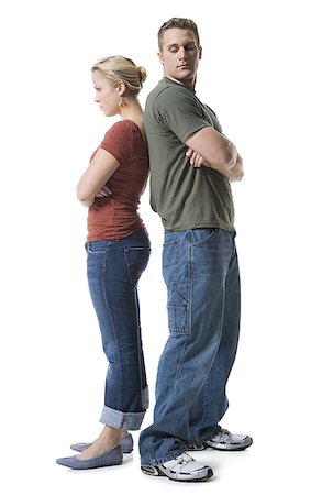 Profile of a young couple standing back to back Stock Photo - Premium Royalty-Free, Code: 640-02768401