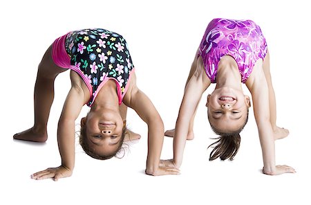 Young female gymnasts bending backwards Foto de stock - Royalty Free Premium, Número: 640-02768444