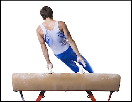 Male gymnast performing on vaulting horse Stock Photo - Premium Royalty-Free, Code: 640-02768479