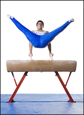 Male gymnast performing on vaulting horse Stock Photo - Premium Royalty-Free, Code: 640-02768480