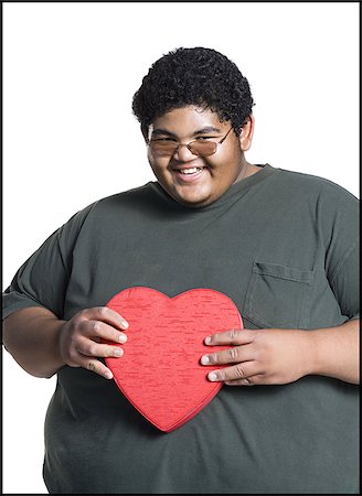 fat teen - Heavyset young man with valentine box Stock Photo - Premium Royalty-Free, Code: 640-02768513