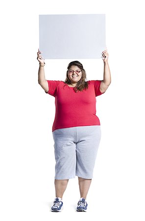 Heavyset young woman holding blank sign Stock Photo - Premium Royalty-Free, Code: 640-02768522