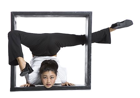 female contortionist in box - Female contortionist businesswoman inside the box Stock Photo - Premium Royalty-Free, Code: 640-02768596