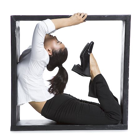 simsearch:640-02768663,k - Female contortionist businesswoman inside the box Foto de stock - Sin royalties Premium, Código: 640-02768593