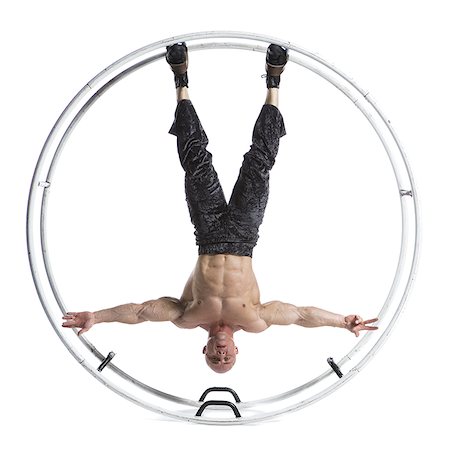 Male bodybuilder posing in German wheel Stock Photo - Premium Royalty-Free, Code: 640-02768637