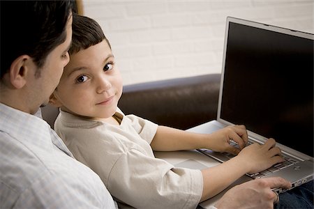 simsearch:640-01352373,k - Father and young son working on laptop computer Fotografie stock - Premium Royalty-Free, Codice: 640-02768767
