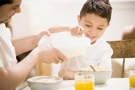 Father and young son having breakfast together Stock Photo - Premium Royalty-Free, Code: 640-02768775