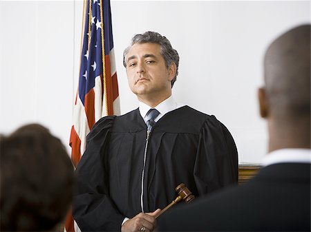 Judge standing in front of defendants and lawyers Stock Photo - Premium Royalty-Free, Code: 640-02768821