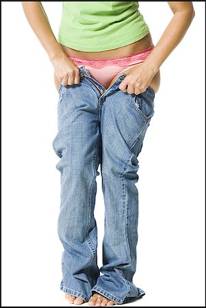 female and weight gain - Young woman having trouble getting into pants Stock Photo - Premium Royalty-Free, Code: 640-02768861
