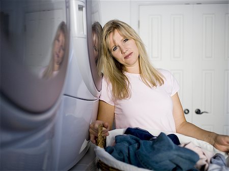 family with washing machine - Woman doing laundry Stock Photo - Premium Royalty-Free, Code: 640-02768996