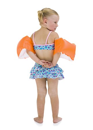 Young girl with personal flotation devices around arms Stock Photo - Premium Royalty-Free, Code: 640-02769070