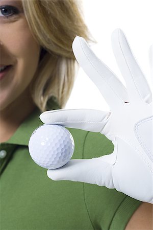 Female golfer and close-up of golf ball Stock Photo - Premium Royalty-Free, Code: 640-02769280