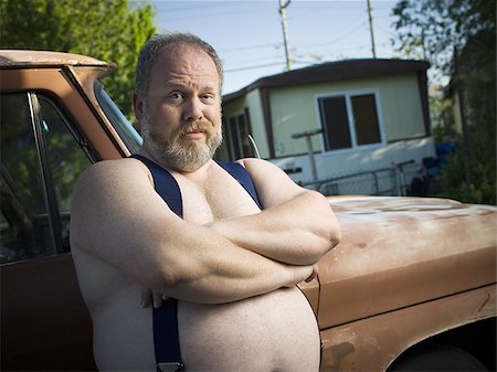 redneck man - Overweight man with suspenders by truck Stock Photo - Premium Royalty-Free, Code: 640-02769476