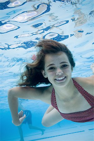 swimmer in water below - Girl swimming underwater in pool Stock Photo - Premium Royalty-Free, Code: 640-02769487
