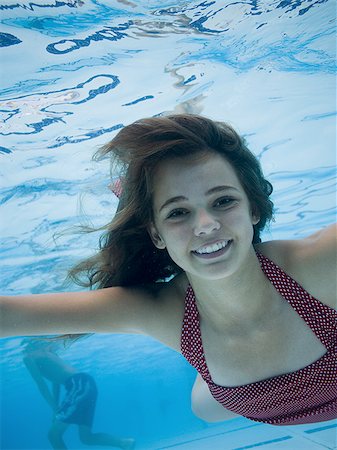 swimmer in water below - Girl swimming underwater in pool Stock Photo - Premium Royalty-Free, Code: 640-02769488