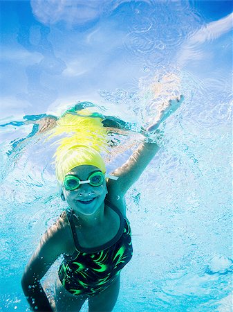 female swimmer cap goggles - Girl swimming underwater in pool Stock Photo - Premium Royalty-Free, Code: 640-02769525