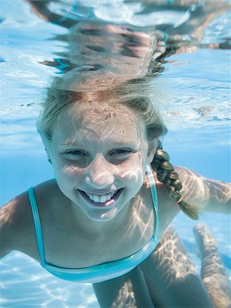 swimmer in water below - Girl swimming underwater in pool Stock Photo - Premium Royalty-Free, Code: 640-02769535