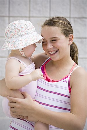 sister hugs baby - Girl holding baby Stock Photo - Premium Royalty-Free, Code: 640-02769606