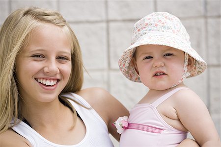 sister hugs baby - Two young sisters Stock Photo - Premium Royalty-Free, Code: 640-02769601