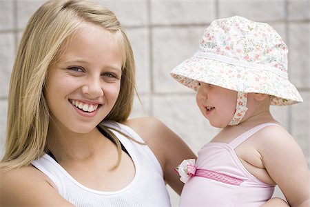 sister hugs baby - Two young sisters Stock Photo - Premium Royalty-Free, Code: 640-02769602