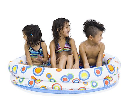 simsearch:640-02769656,k - Three young children playing in inflatable pool Foto de stock - Sin royalties Premium, Código: 640-02769656