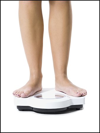 foot concept - Dieting woman standing on bathroom scale Stock Photo - Premium Royalty-Free, Code: 640-02769706