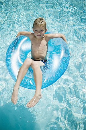 Boys on Float Tubes in Swimming Pool Stock Image - Image of