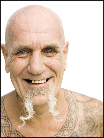 face man tatoo - Heavily tattooed man smiling Stock Photo - Premium Royalty-Free, Code: 640-02769776