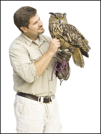 european eagle owl - Animal handler with owl Foto de stock - Sin royalties Premium, Código: 640-02769781